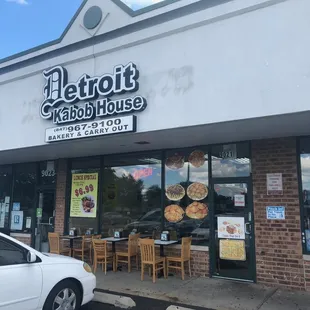 Storefront with a little outdoor seating.