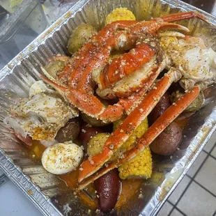 crab legs, potatoes, corn, and potatoes