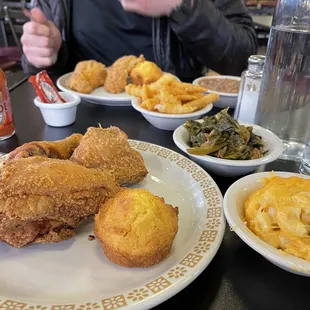 The whole spread - fried chicken and catfish dinners with collard greens, Mac and cheese + fries