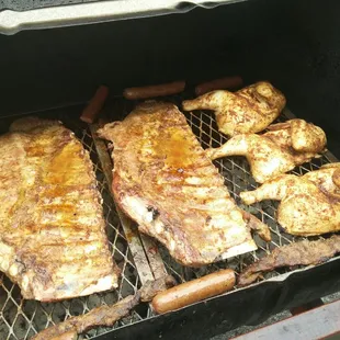 Ribs, chicken sausage over charcoal.