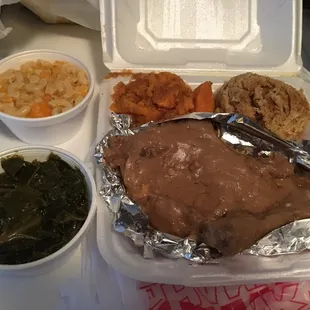 Smothered pork chops with collard greens, mac and cheese, yams, and dressing (without gravy).  (Photo taken without flash)