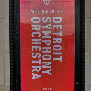 a red poster with the words welcome to the detroit symphony