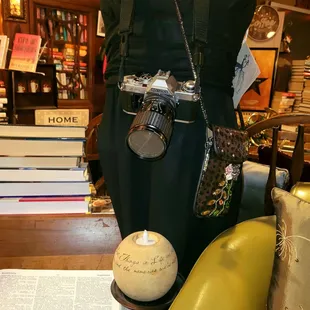 a mannequin with a camera and a book