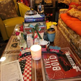 a coffee table with books and a candle