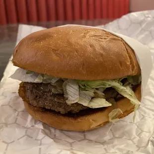 a hamburger with lettuce and onions