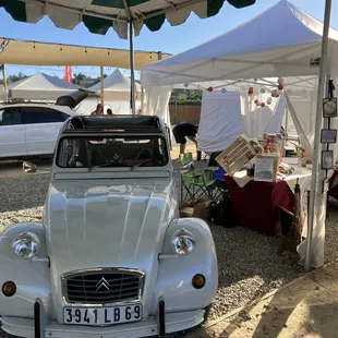 an old car parked under a tent
