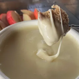 a spoon dipping a bowl of fond