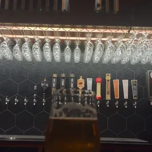 a glass of beer in front of a bar