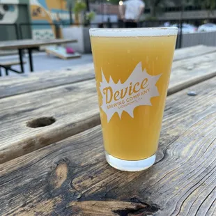 a glass of beer on a picnic table