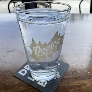 a glass of water on a coaster