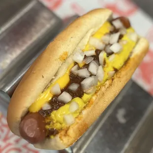 a hot dog with mustard and onions