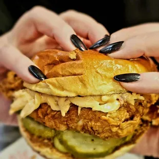 hands holding a chicken sandwich