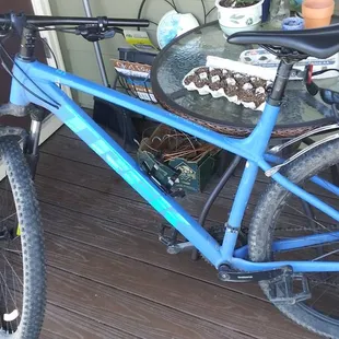 a blue bicycle parked on a porch
