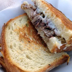 The amazing "Duck Confit Grilled Cheese": shredded duck confit, gruyere and mozzarella cheeses, honey port reduction, sourdough bread.