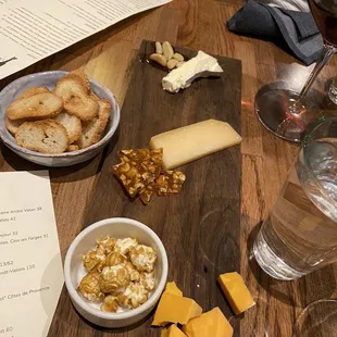 cheese and crackers on a cutting board