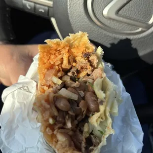 Close up of the inside of a carne asada burrito - see how very little meat.