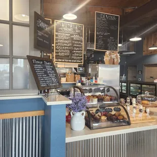a bakery counter with a variety of pastries