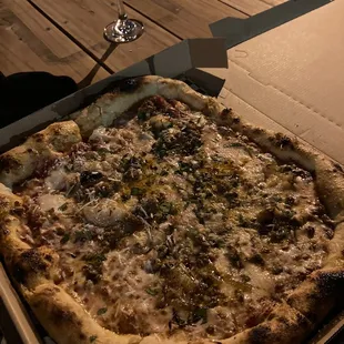 a pizza and a glass of wine