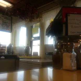 a view of a counter with a cup of coffee and a salt shaker