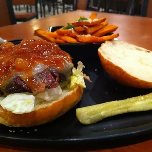 a hamburger and pickle on a plate