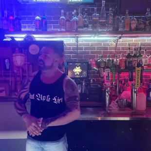 a man standing behind the bar