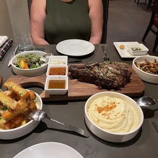 Loaded fries, potato purée, sautéed mushrooms, vegetable medley, 28oz bone in ribeye.