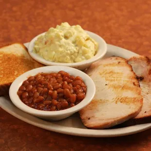 ows a plate of meat, beans, and toast