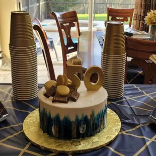 a table with a cake and cups
