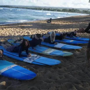 Lead instructor Jacob teaches the basics of surfing on the beach.