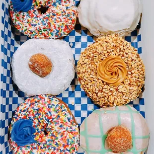 Assortment of donuts (Sprinkles; Powdered Sugar; Peanut Butter; Glazed; Cinnamon Bun)