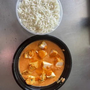 a bowl of rice and a bowl of chicken curry