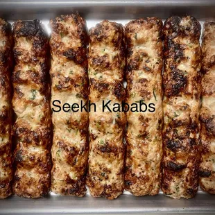 a close up of a tray of chicken kababs