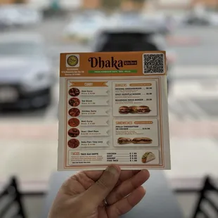 a person holding up a menu