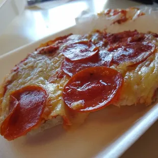 a slice of pepperoni pizza