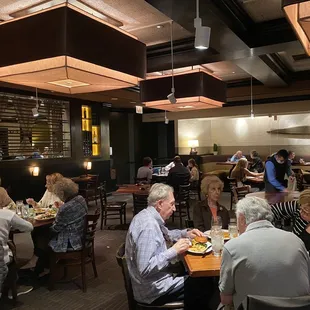 a large group of people eating at a restaurant
