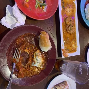 Meat lasagna,salad,shrimp scampi, and baklava.