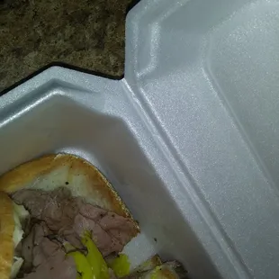 a roast beef sandwich in a styrofoam container