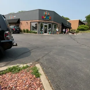 a parking lot with cars parked in front of it