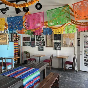 a long table with colorful decorations hanging from the ceiling