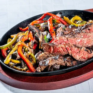 steak and peppers in a skillet