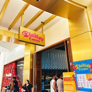 a group of people standing outside of a restaurant