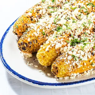 a plate of grilled corn