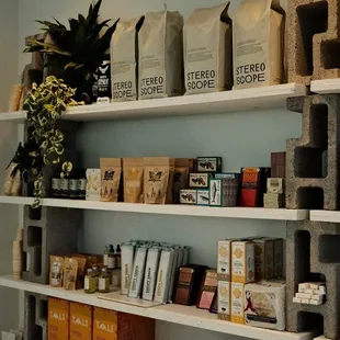 a shelf of coffee beans and coffee bags