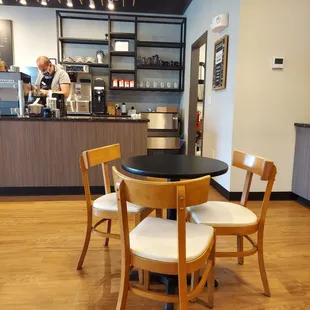 a table and chairs in a coffee shop