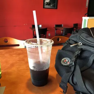 a backpack and a drink