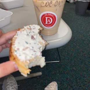 Cheese bagel with artichoke and bacon cream cheese spread .  Coconut macchiato with caramel drizzle