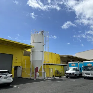 a parking lot with trucks parked in front of it