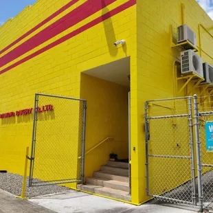 The building is bright yellow - can't miss it!