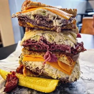 a stack of sandwiches with pickles