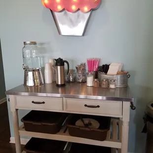 a cupcake sign above the counter